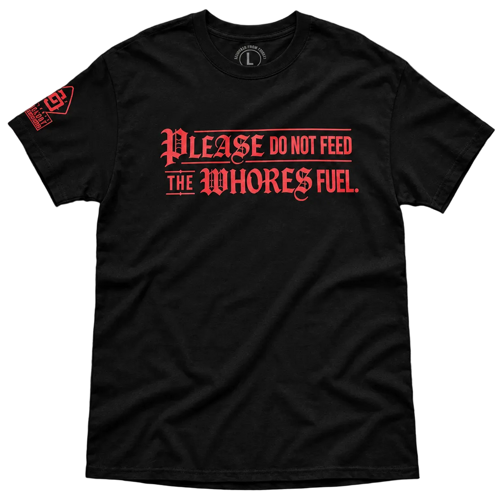 A black short-sleeve t-shirt with a red gothic-style text graphic on the front reading 'PLEASE DO NOT FEED THE WHORES FUEL.' and a red graphic on the left sleeve, shown on a plain white background.